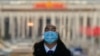 A soldier dressed as an usher stands guard at an entrance door of the Great Hall of the People in Beijing, March 3, 2023.