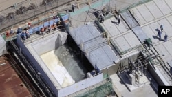 This aerial view shows the treated water diluted by seawater flowing into a secondary water then into a tunnel for an offshore discharge at the Fukushima Daiichi nuclear power plant in Fukushima, Japan, Aug. 24, 2023.