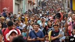Migrants start walking north on their way to Mexico City from Tapachula, Chiapas state, Mexico, April 23, 2023.