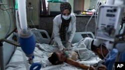 A Palestinian boy wounded during an Israeli airstrike receives medical treatment at Nasser Hospital in Khan Younis, Gaza Strip, Oct. 15, 2023. 