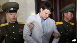 FILE - American student Otto Warmbier is escorted at the Supreme Court in Pyongyang, North Korea, March 16, 2016.