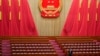Seorang pejabat bersiap jelang rapat pleno kedua Kongres Rakyat Nasional (NPC) di Aula Besar Rakyat di Beijing, China, Jumat, 8 Maret 2024. (Foto: Tatan Syuflana/AFP).