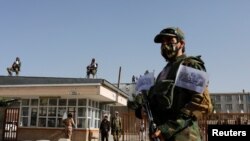 FILE - Taliban soldiers stand guard at the second-anniversary ceremony of the takeover of Kabul by the Taliban in Kabul, Afghanistan, August 15, 2023.