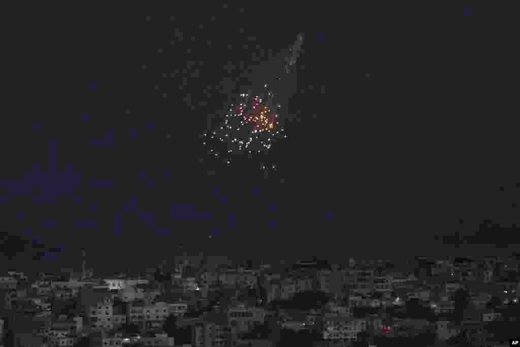 A shell from Israeli artillery explodes over Bastra Farms in the disputed Shebaa Farms territory, south Lebanon. A Lebanese security official said six rockets were fired from southern Lebanon into northern Israel. (AP Photo/Hussein Malla)