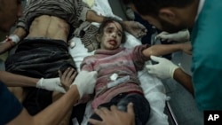 Palestinians wounded in the Israeli bombardment of the Gaza Strip arrive at a hospital in Rafah, Dec. 6, 2023. 