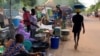 FILE - A man walks past a street side market in Niamey, Sept. 20, 2023. A lawsuit filed by Niger's transitional leaders over sanctions on Niger was dismissed on Dec. 7, 2023. Since the sanctions were imposed following the July coup, millions of citizens have struggled to get by. 