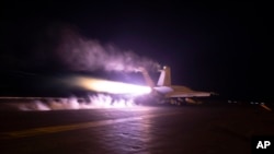 This image provided by the U.S. Navy shows an aircraft launching from USS Dwight D. Eisenhower during Red Sea flight operations, Jan. 22, 2024. U.S. and British militaries have bombed multiple targets used by the Iranian-backed Houthis in Yemen.