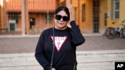Lusiana, a transgender woman from Argentina, stands in front of the Beata Vergine Immacolata parish church in Torvaianica, Italy, Nov. 16, 2023.