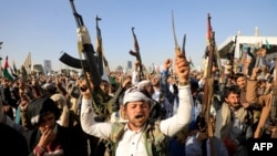 Wapiganaji wa Kihouthi wakionyesha silaha zao kupinga mashambulizi yaliyofanywa na majeshi ya Marekani an Uingereza katika mji uliokuwa chini ya mamlaka ya Wahouthi huko Sanaa.