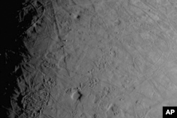 This image made available by NASA shows the complex, ice-covered surface of Jupiter's moon Europa, captured by NASA's Juno spacecraft during a flyby on Thursday, Sept. 29, 2022. (NASA/JPL-Caltech/SWRI/MSSS via AP)