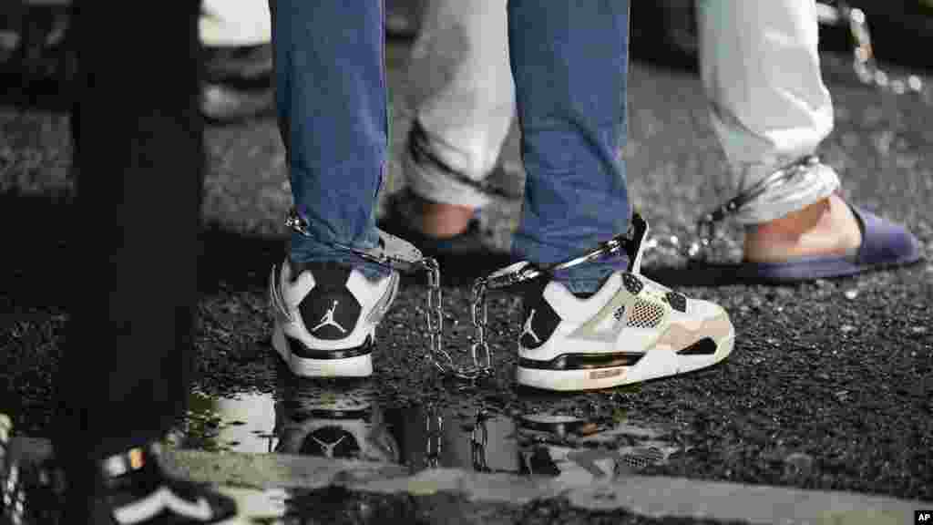 Ecuadorian migrants line up in shackles to board a plane for deportation from Albrook airport in Panama City, Aug. 29, 2024.