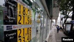 Un tablero que muestra el tipo de cambio del peso mexicano y el dólar estadounidense se ve en un banco en la Ciudad de México, México, 14 de noviembre de 2016.