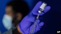 FILE - A nurse practitioner prepares a syringe with the Mpox vaccine before inoculating a patient at a vaccinations site in the Brooklyn borough of New York City, Aug. 30, 2022.