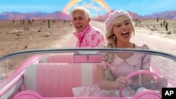 This image released by Warner Bros. Pictures shows Ryan Gosling, left, and Margot Robbie in a scene from "Barbie." (Warner Brothers via AP)