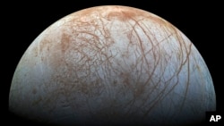 This image made available by NASA in 2014 shows Jupiter's icy moon Europa in a reprocessed color view, made from images captured by NASA's Galileo spacecraft in the late 1990s. (NASA/JPL-Caltech/SETI Institute via AP)