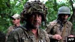 A Ukrainian artilleryman poses as he holds a position at the frontline near the town of Bakhmut, Donetsk region, on July 15, 2023.