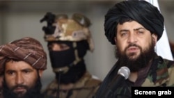 Taliban Defense Minister Muhammad Yaqoob, right, is seen in a screen grab from Afghan state TV.