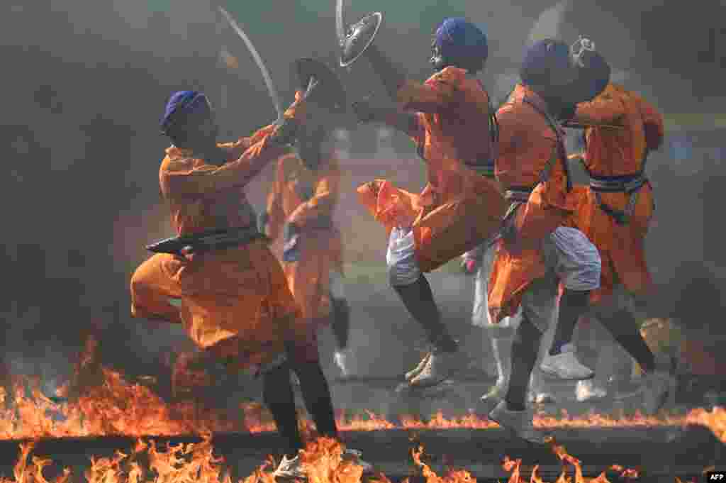 Cadets of the Sikh Regimental Center perform Gatka martial stunts during a combined display ahead of a graduation ceremony at the Officers Training Academy, in Chennai, India.