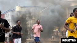 People run away during an anti-government protest, in Freetown, Sierra Leone, August 10, 2022 in this picture obtained from social media.