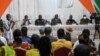 FILE - Ivory Coast officials address the relatives of the 49 Ivorian soldiers detained in Mali, in Abidjan, Aug. 3, 2022.