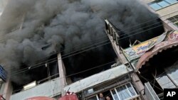 Palestinians remove debris from a building that was damaged in an Israeli strike, in Gaza City, Nov. 19, 2012. 