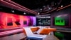 FILE - An anchor of the RT (formerly Russia Today) TV company is seen as he prepares to go on the air in on the the broadcaster's studios in Moscow, June 8, 2018.