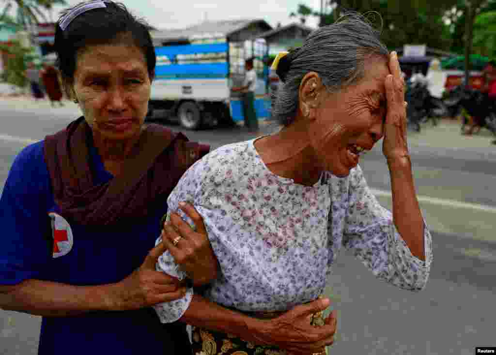 The grandmother of Tun Tun, a 36-year-old funeral bus driver killed in a recent riot, cries at a cemetery in Mandalay, Myanmar, July 3, 2014.