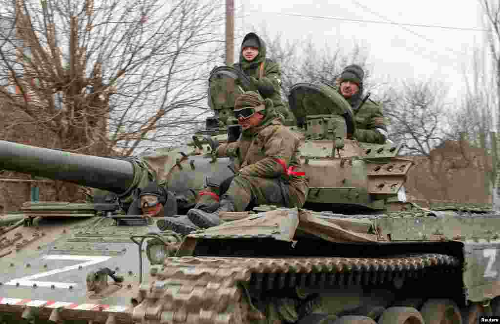 Service members of pro-Russian troops in uniforms without insignia are seen atop of a tank with the letter "Z" painted on its sides in the separatist-controlled settlement of Buhas (Bugas), as Russia's invasion of Ukraine continues, in the Donetsk region, Ukraine, March 1, 2022.