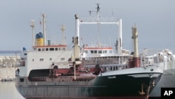 FILE - A ship believed to be carrying three containers of weapons is docked at a Lebanese navy base, in Beirut, Lebanon, April 28, 2012. The ship came from Libya via Egypt, and then to the port of the Lebanese north city of Tripoli on its way to Syria, according to Lebanon's state-run National News Agency. 
