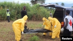 FILE: A team carries the body of an Ebola victim in Freetown, Sierra Leone. At least 70 percent of the country’s burials are conducted safely, the World Health Organization reports. 
