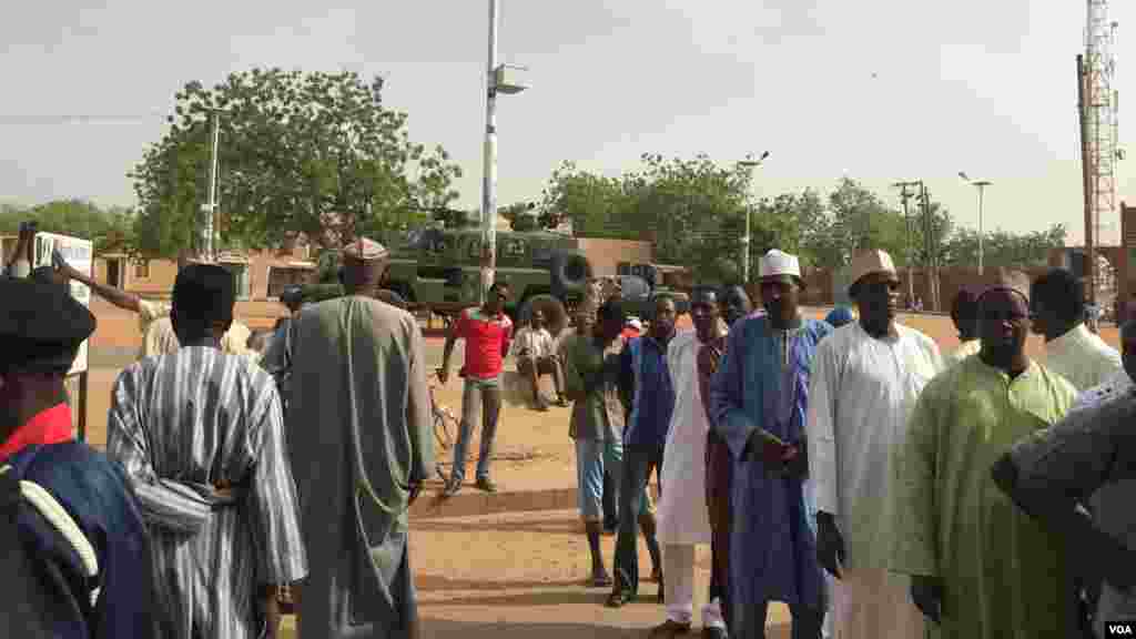 In Daura, hometown of APC presidential candidate General Muhammadu Buhari, a Nigerian Army armored attack vehicle and two military pickups sit outside the emir's palace across from a polling unit where people are lined up to vote.