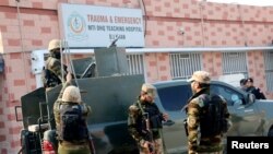 Petugas keamanan berjaga di luar rumah sakit tempat petugas polisi yang terluka dirawat setelah serangan militan di kantor polisi di Dera Ismail Khan, Pakistan, 5 Februari 2024. (REUTERS/Stringer)