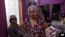 Aurora Falconi shows old photos of her slain daughter, journalist Yessenia Mollinedo Falconi, during her daughter's wake in Minatitlan, Veracruz state, Mexico, May 10, 2022.
