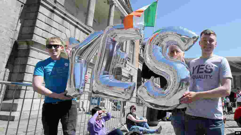 Supporters for same-sex marriage hold an inflatable "Yes" sign as they waited for the announcement on the referendum, which was approved, in Dublin castle, May 23, 2015.
