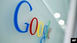 FILE - Google logo is seen at the Google headquarters in Brussels.