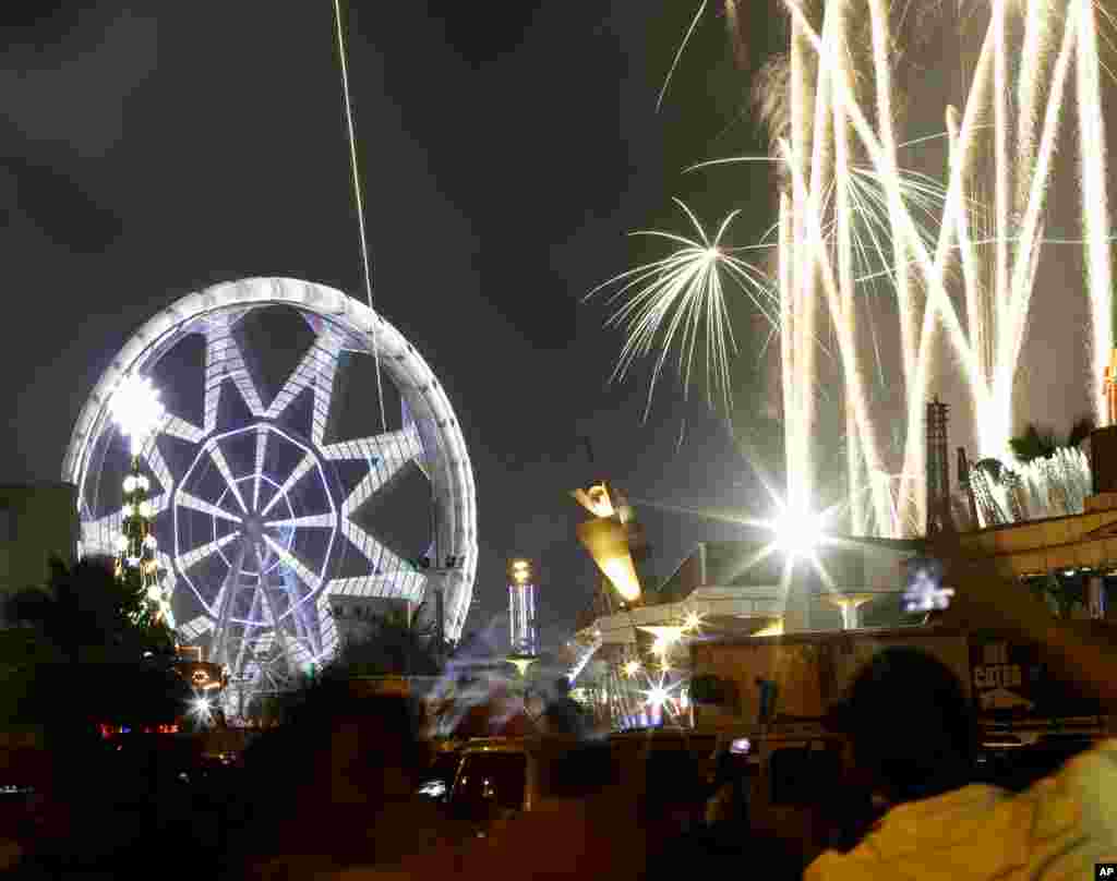 Fireworks light up the sky as onlookers welcome the new year, Manila, Philippines, Jan. 1, 2014.
