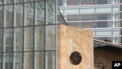 A man walks past the Robert H. Jackson U.S. Courthouse in Buffalo N.Y., where Pascale Ferrier is expected to appear in federal court, Sept. 22, 2020.