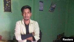 Satish Bhaykre, 21, who was beaten by a mob due to a fake WhatsApp text, poses inside his house on the outskirts of Nagpur, India, June 23, 2018. 