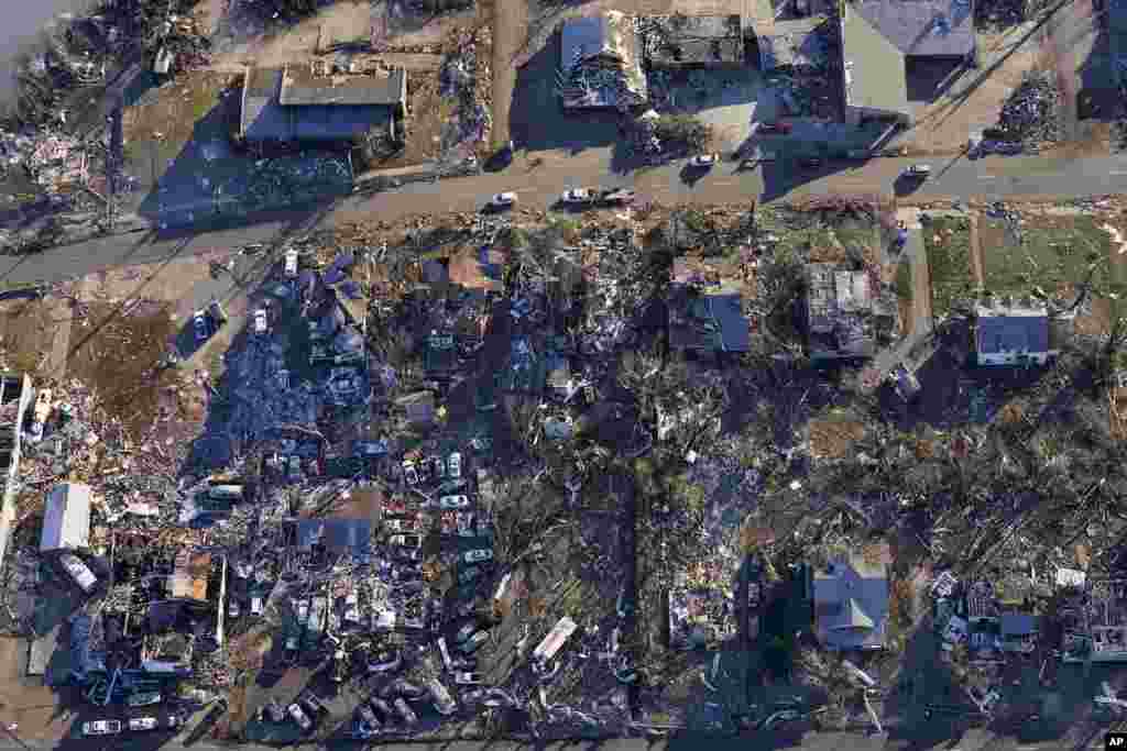 In this aerial photo, destruction from a recent tornado is seen in downtown Mayfield, Kentucky. Governor Andy Beshear is warning the state’s death toll from an outbreak of tornadoes could top 100. 