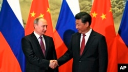 2016年6月25日中国国家主席习近平在北京会晤到访的俄罗斯总统普京。（美联社）