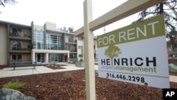 FILE- This Jan. 8, 2017, file photo shows a "For Rent" sign outside an apartment building in Sacramento, Calif.