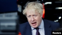 FILE - Britain's Foreign Secretary Boris Johnson talks to reporters as he arrives at a European Union foreign ministers meeting in Brussels, Belgium, March 19, 2018. 