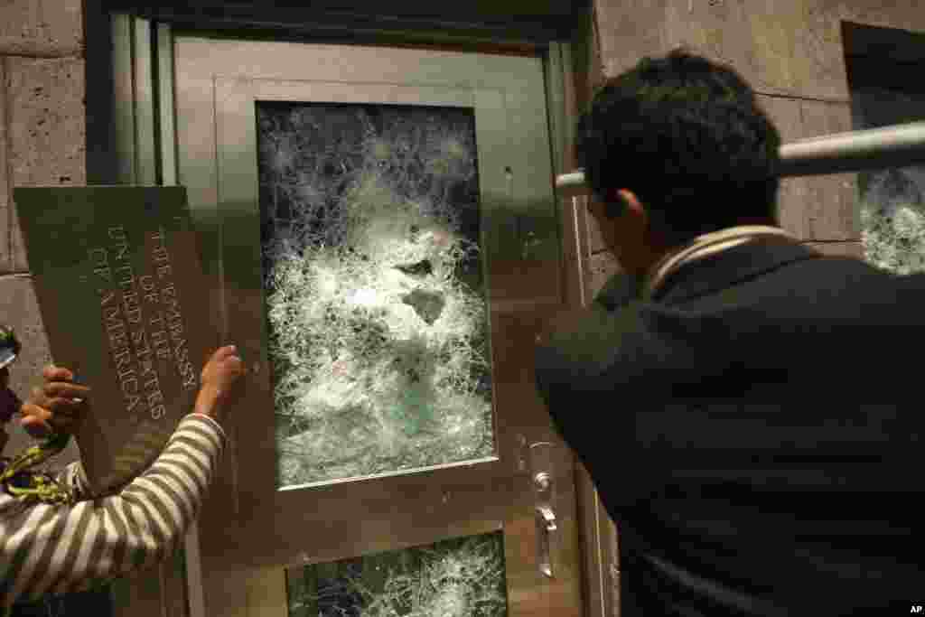 Yemeni protestors break a door of the U.S. Embassy during a protest about a film ridiculing Islam's Prophet Mohammed, Sana'a, Yemen, September 13, 2012.
