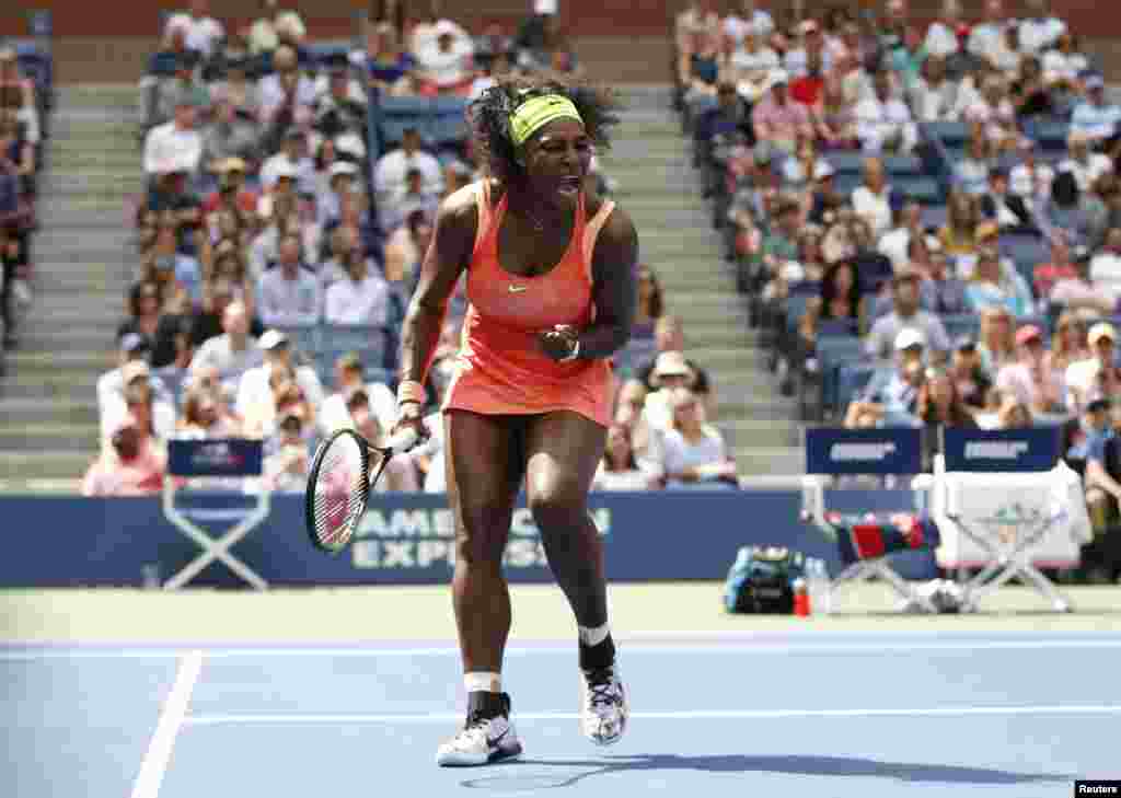 Serena Williams of the U.S. celebrates a point against Roberta Vinci of Italy during their women's singles semi-final match at the U.S. Open Championships tennis tournament in New York.
