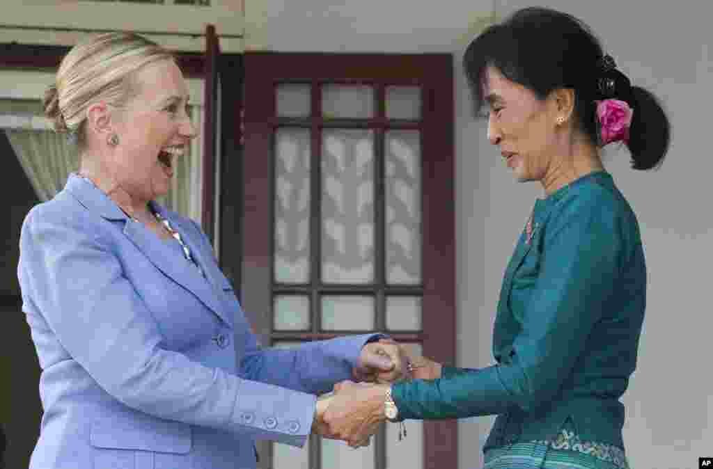 Aung San Suu Kyi, right, and U.S. Secretary of State Hillary Clinton react after speaking to the press at Suu Kyi's residence in Rangoon, Burma, December 2, 2011.