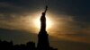 The sun rises behind the Statue of Liberty a day before the United States celebrates its independence, July 3, 2016, in Jersey City, N.J. 