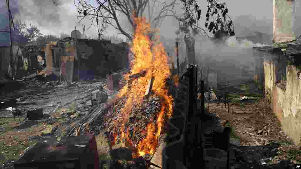 Homes burn after being hit by a shell in Donetsk, eastern Ukraine, Sept. 7, 2014.