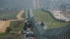 FILE - A motorcade carrying President Donald Trump drives along the border in San Diego, March 13, 2018.