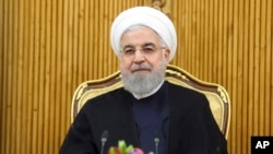 In this photo released by the official website of the office of the Iranian Presidency, President Hassan Rouhani sits at the Mehrabad airport pavilion before leaving Tehran, Iran, for New York to attend United Nations General Assembly, Monday, Sept…