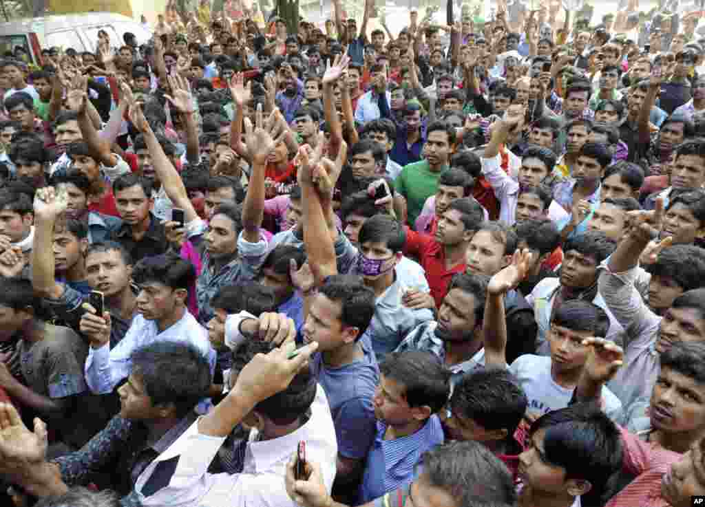 Bangladeshis protest outside a garment-factory where a fire killed more than 100 people Saturday on the outskirts of Dhaka, Bangladesh, November 26, 2012.